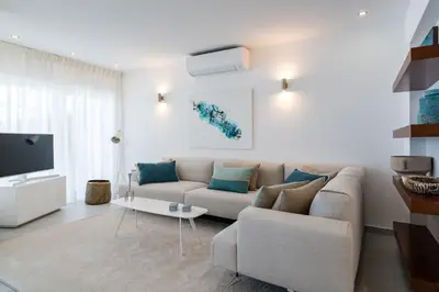 a living room with a couch and a tv at Villa Celeste by SAPvillas in Vilamoura