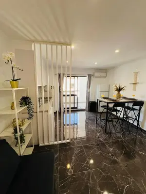 a living room with a table and a dining room at Brand New Studio in Rua da Oura in Albufeira