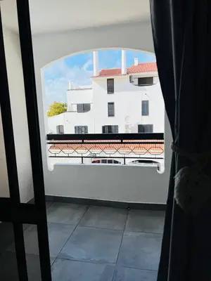 a view of a white building from a window at Brand New Studio in Rua da Oura in Albufeira