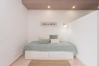 a bedroom with a bed in a white room at Central Apartment by Ocvillas in Albufeira
