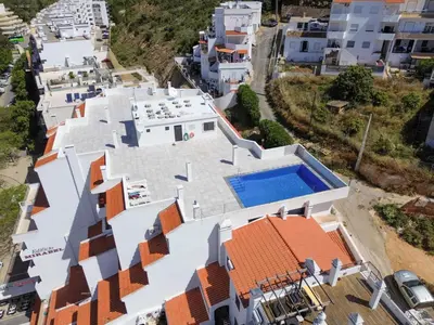 an aerial view of a white house with a swimming pool at Central Apartment by Ocvillas in Albufeira