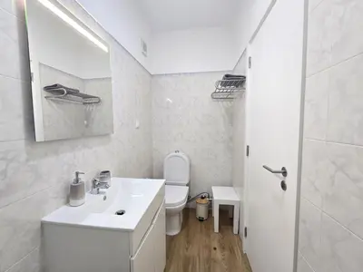 a bedroom with a large bed and a chair at Modern Beach Apartment - Avenida Mar 2 - 150 mts da praia in Quarteira
