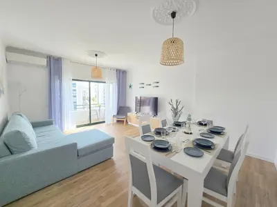 a white bathroom with a sink and a shower at Modern Beach Apartment - Avenida Mar 2 - 150 mts da praia in Quarteira