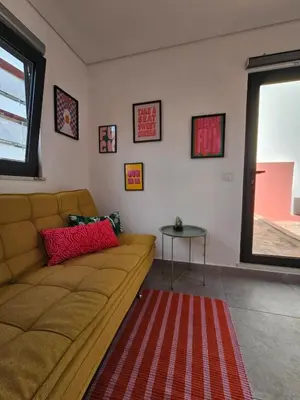 a living room with a couch and a table at City Center Terrace in Faro