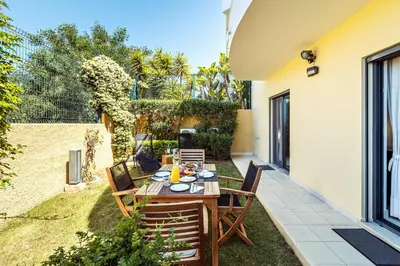 a patio with a table and chairs in a backyard at Albufeira Vista Marina Apt - Old Town in Albufeira