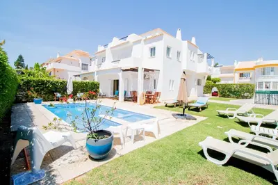a villa with a swimming pool and a house at Vila Anna in Albufeira