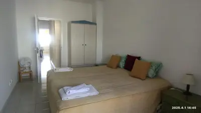 a small bedroom with a bed in a room at Quarteira First Line Front Beach Pool Flat View in Quarteira