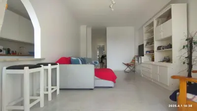 a living room with a couch and a flat screen tv at Quarteira First Line Front Beach Pool Flat View in Quarteira