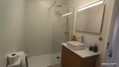 a bathroom with a shower and a sink and a toilet at Quarteira First Line Front Beach Pool Flat View in Quarteira