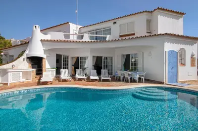 a villa with a swimming pool in front of a house at Villa Rebelo in Albufeira