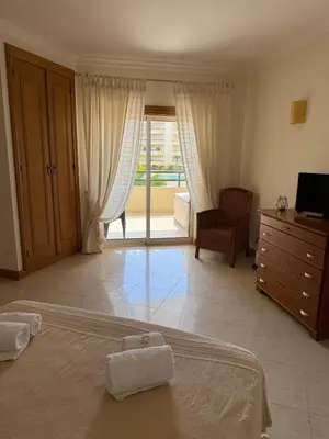 a bedroom with a bed with two towels on it at Galé Mar By Albufeira Rental in Albufeira
