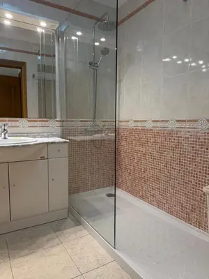 a bathroom with a glass shower and a sink at Galé Mar By Albufeira Rental in Albufeira