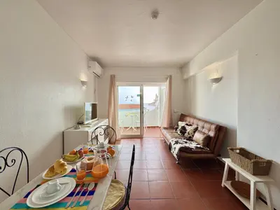 a living room with a couch and a table at Albufeira Ocean View III by Homing in Albufeira