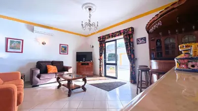 a living room with a couch and a table at Casa das ficus in Guia