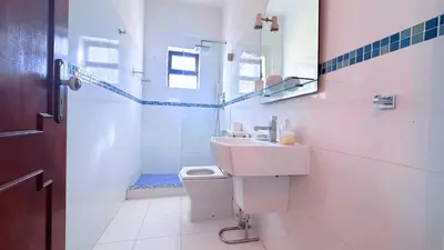 a bathroom with a sink and a toilet and a shower at Casa das ficus in Guia