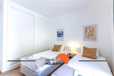 two beds in a room with a window at #293 Clube Albufeira 309 by Home Holidays in Albufeira