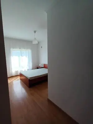 a bedroom with a bed and a wooden floor at T2 Faro in Faro