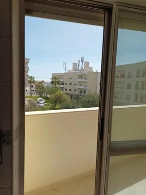 a window with a view of a city from a building at T2 Faro in Faro