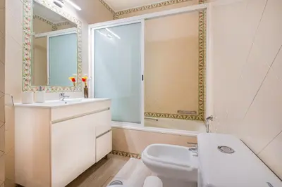 a white bathroom with a sink and a mirror at Azinhais Apartment - Heart of Oura in Albufeira
