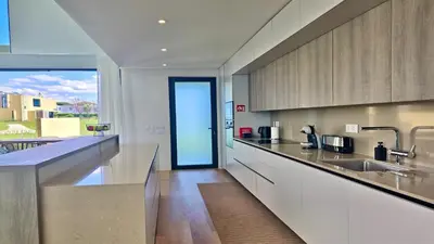 a kitchen with a sink and a view of a yard at Villa Essence by Clever Details, private pool, central location in Vilamoura