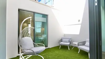 a living room with a couch and a desk at Villa Essence by Clever Details, private pool, central location in Vilamoura
