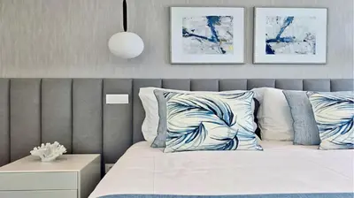 a white bedroom with a bed and a chair at Villa Essence by Clever Details, private pool, central location in Vilamoura