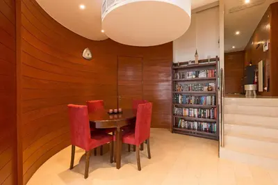 a dining room with a table and red chairs at Sunny Lounge Apartment in Vale do Lobo