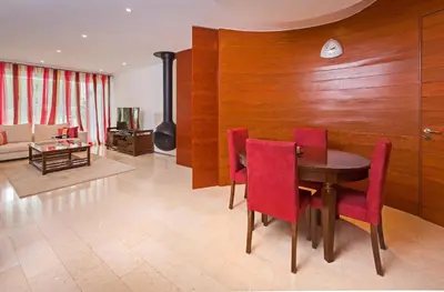 a dining room with a table and red chairs at Sunny Lounge Apartment in Vale do Lobo
