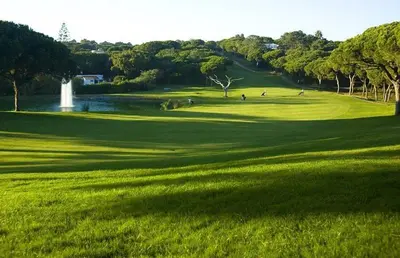 a lush green golf course with a water fountain at Sunny Lounge Apartment in Vale do Lobo