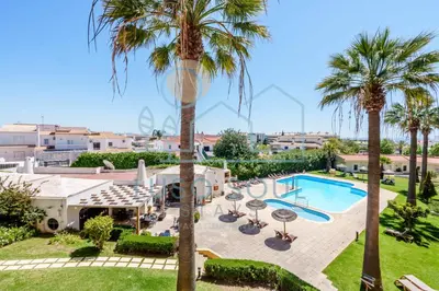 an image of a villa with a swimming pool and palm trees at NEW! Perfect Studio with Swimming Pool in Albufeira
