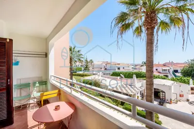 a balcony with a palm tree and a view at NEW! Perfect Studio with Swimming Pool in Albufeira