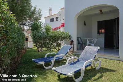 three blue and white chairs and a table on a yard at Akivillas Quarteira Relax in Quarteira
