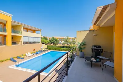 a balcony with a swimming pool in a building at Vale Parra Village By Cabritatur in Guia