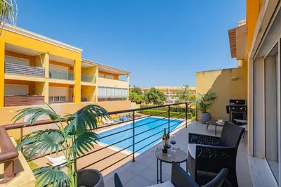 a balcony with a swimming pool on a building at Vale Parra Village By Cabritatur in Guia