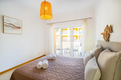 a bedroom with a bed with slippers on it at Vale Parra Village By Cabritatur in Guia