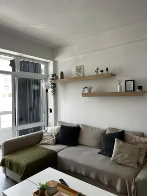 a living room with a couch and a window at Quarteira Beach Home Haven in Quarteira