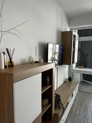 a kitchen with a counter with a tv on it at Quarteira Beach Home Haven in Quarteira