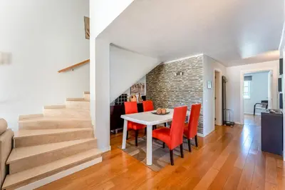 a dining room with a table and red chairs at Casa da Paz by Algarve Holidays in Albufeira