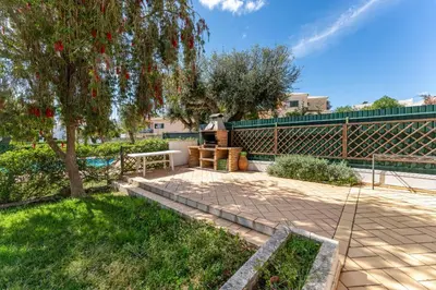 a patio with a tree and a fence at Casa da Paz by Algarve Holidays in Albufeira