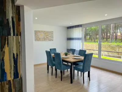 a dining room with a table and chairs and a window at Modern Retreat 700m from the Beach - Salgados in Guia