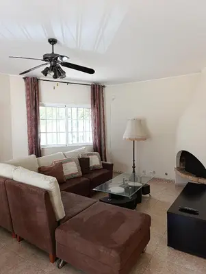 a living room with a couch and a fireplace at Casa Gomez A in Albufeira
