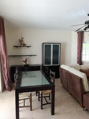 a living room with a table and a couch at Casa Gomez A in Albufeira