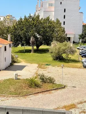 a park with a tree and a building at OuraFlats in Albufeira