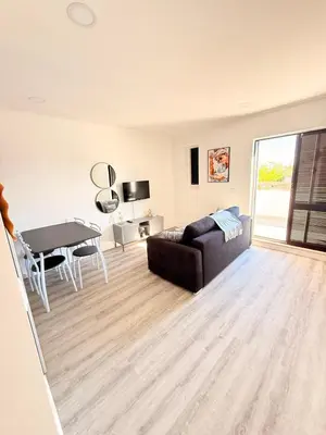 a living room with a couch and a table at OuraFlats in Albufeira
