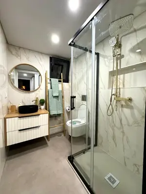 a bathroom with a shower and a sink and a toilet at Acoteias Cosy Studio in Albufeira