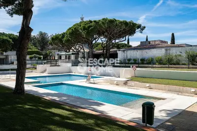 a swimming pool in the yard of a house at Acoteias Cosy Studio in Albufeira