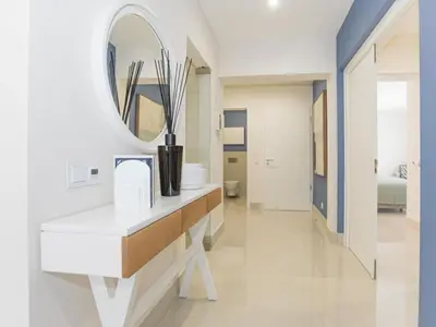 a bathroom with a white vanity and a mirror at Apartment Pine Hills Reva Santuary Modern Elegance by Interhome in Vilamoura