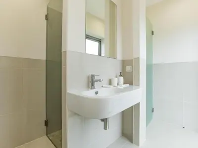 a bathroom with a sink and a mirror at Apartment Pine Hills Reva Santuary Modern Elegance by Interhome in Vilamoura