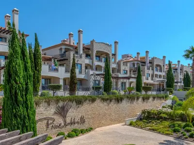 a large building with trees in front of it at Apartment Pine Hills Reva Santuary Modern Elegance by Interhome in Vilamoura