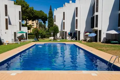 a swimming pool in front of a building at no22FM in Vilamoura